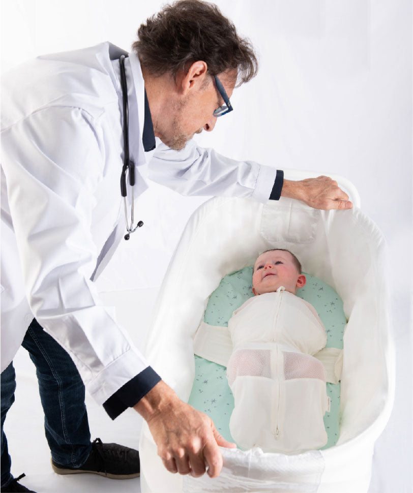 Dr. Harvey Karp looking at a baby in SNOO